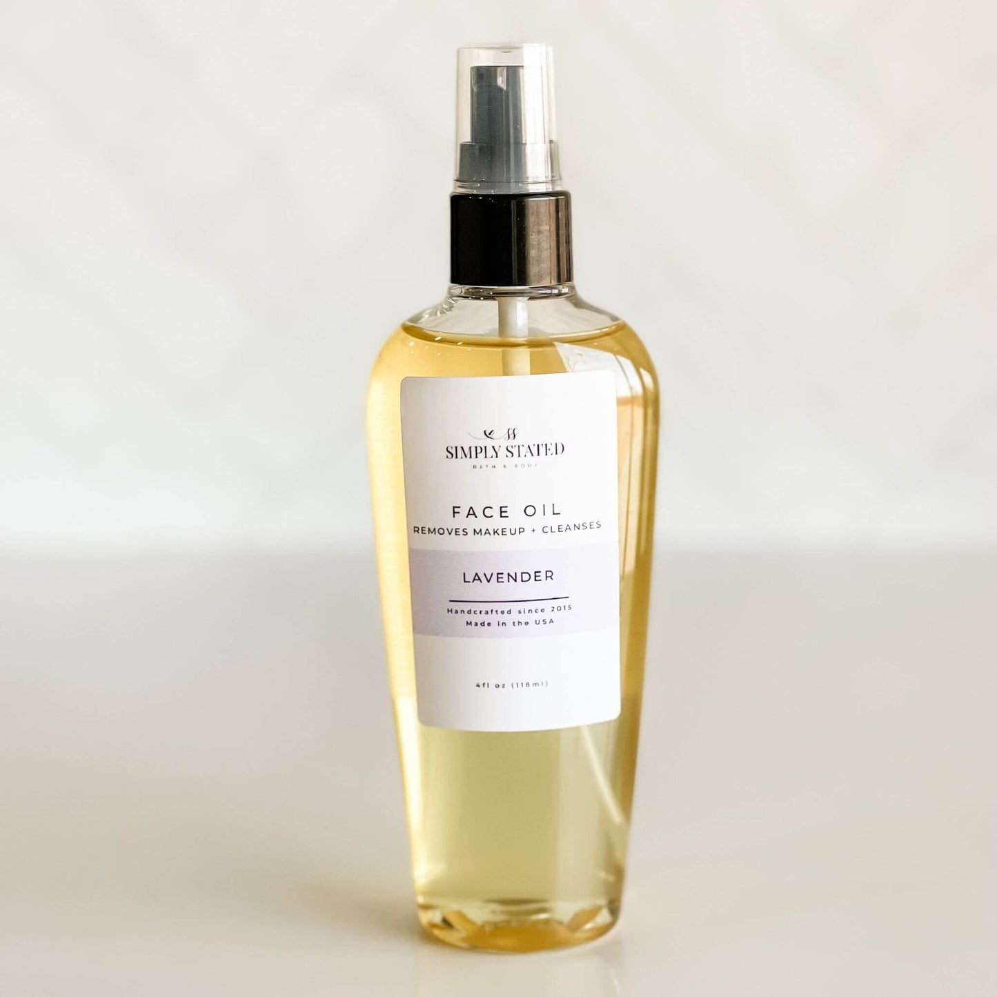 Simply Stated Bath & Body Face Oil in Lavender, a gentle botanical cleanser and makeup remover. Hydrating oil blend with castor oil, sunflower oil, and vitamin E for deep cleansing and nourishment.