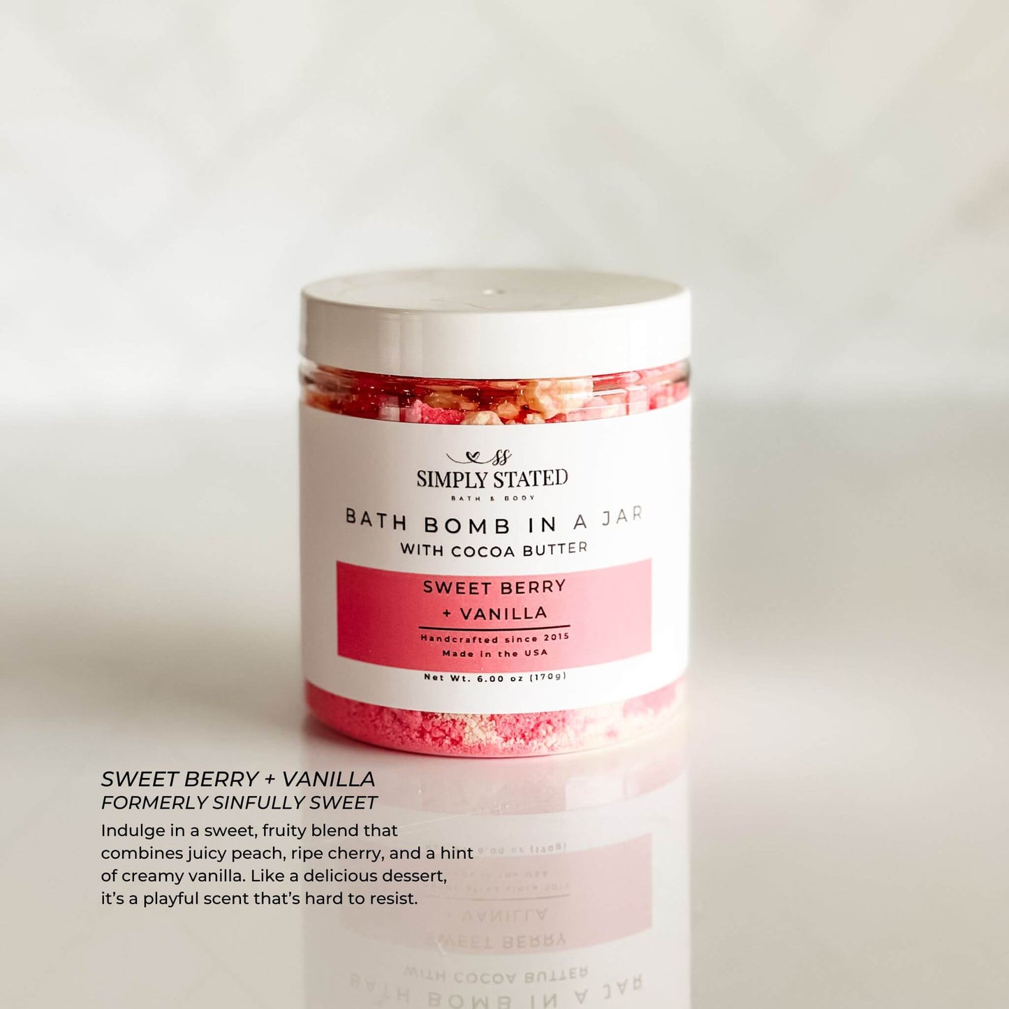 Simply Stated Bath & Body Signature Line Bath Bomb in a Jar - Sweet Berry + Vanilla. A playful and fruity blend of ripe berries, creamy vanilla, and a hint of cherry, creating an indulgent and moisturizing bath experience.