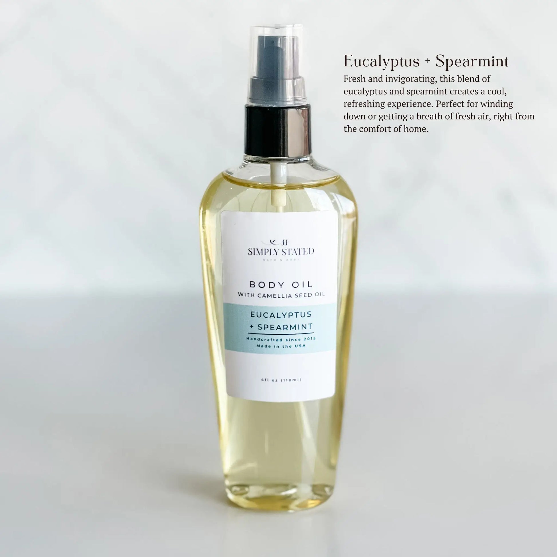 Body oil bottle with a label on a white background. Eucalyptus Spearmint is fresh and invigorating, this blend of eucalyptus and spearmint creates a cool, refreshing experience. Perfect for winding down or getting a breath of fresh air, right from the comfort of home.