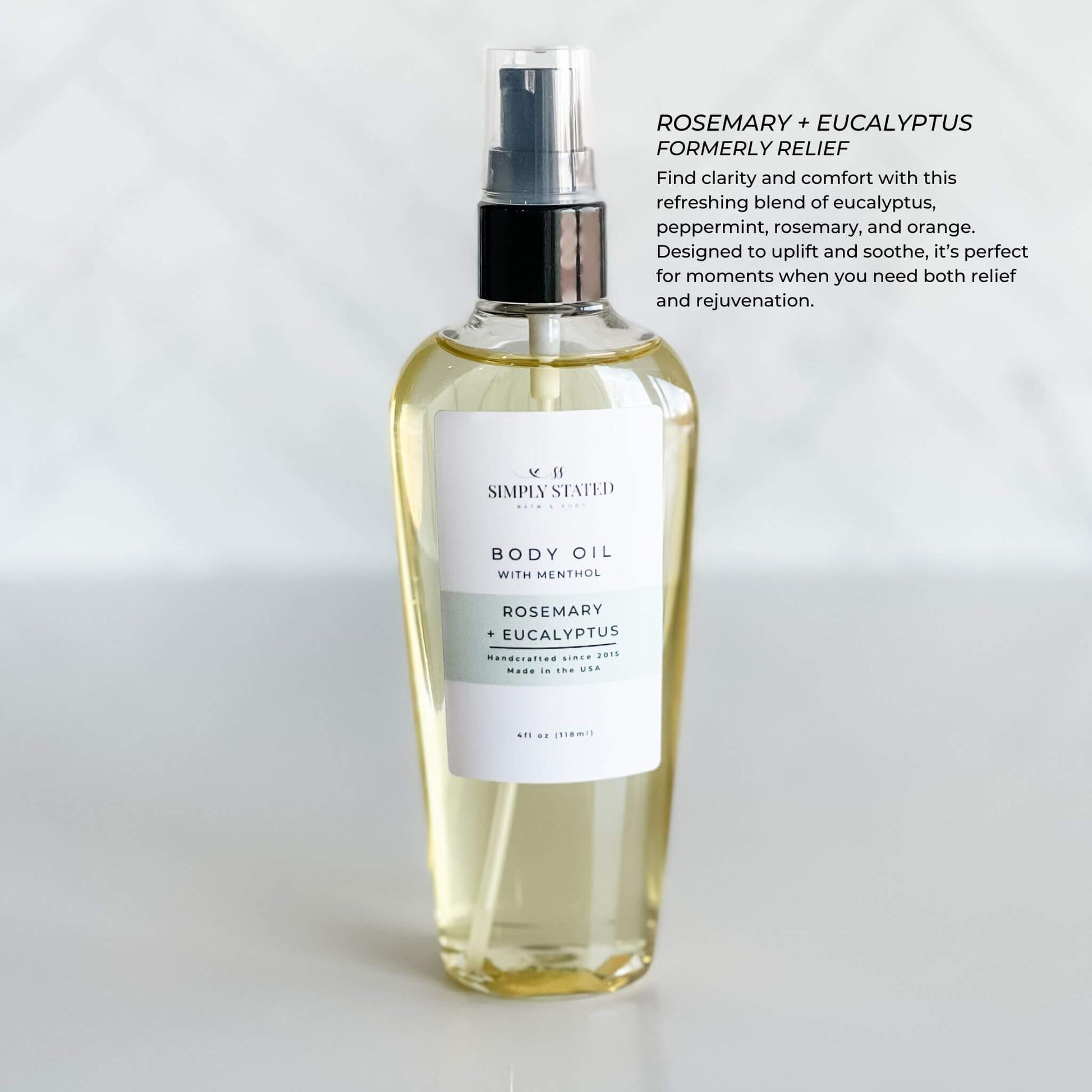 Simply Stated Bath & Body Oil in Rosemary + Eucalyptus with Menthol. Designed for relief and rejuvenation, this essential oil blend uplifts and soothes. Packaged in a 4oz bottle with a treatment pump.