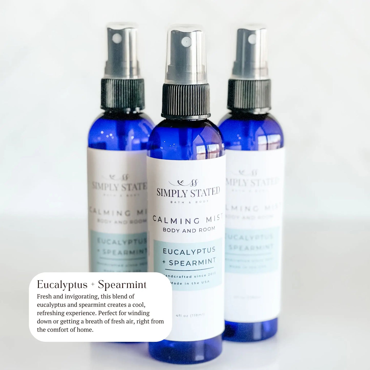 Three bottles of Simply Statesman Calming Mist with Eucalyptus and Spearmint on a white background.