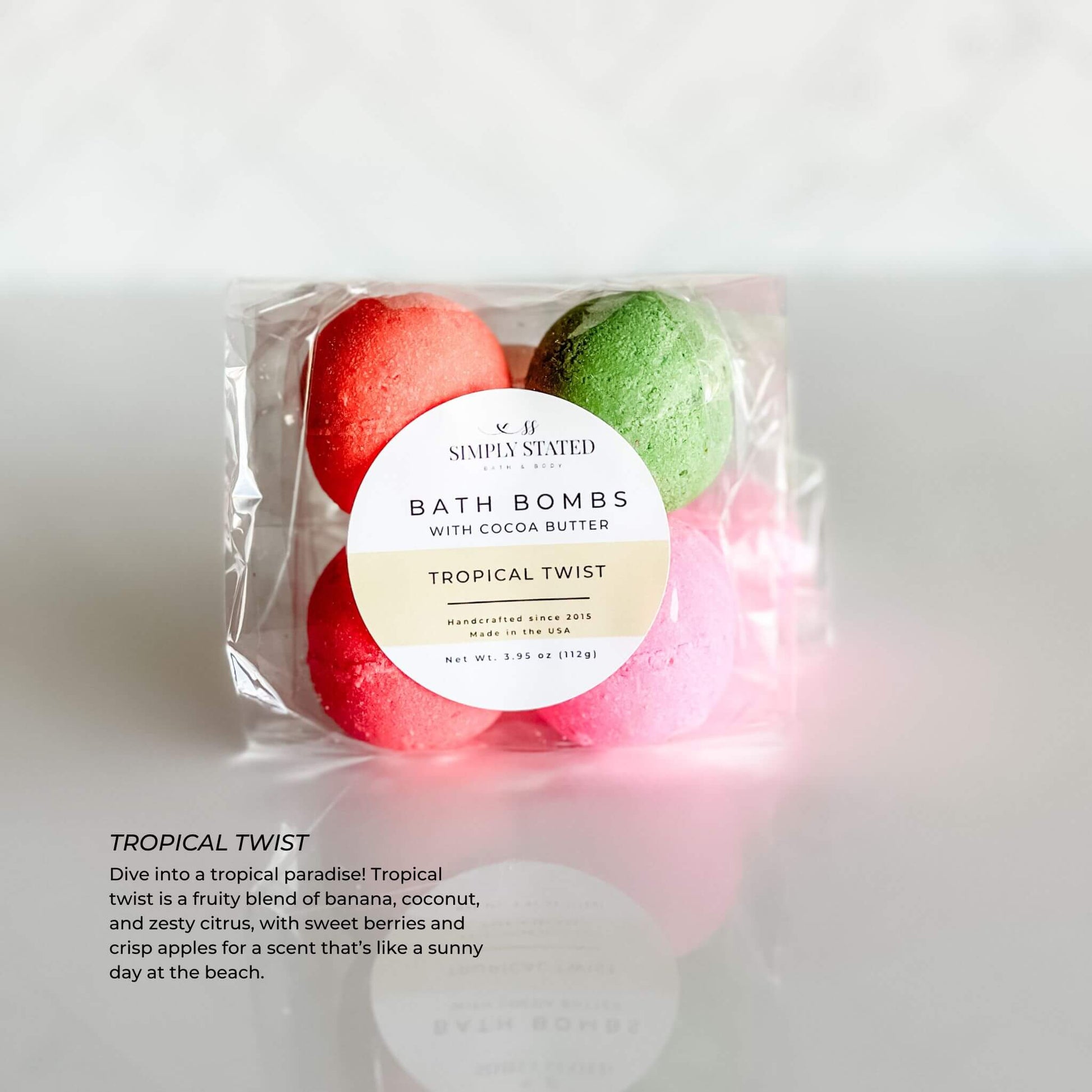 Simply Stated Kids Line Bath Bomb Pack in Tropical Twist scent, with bright red and green bath bombs paired with a sunny yellow label, packaged in a clear bag.