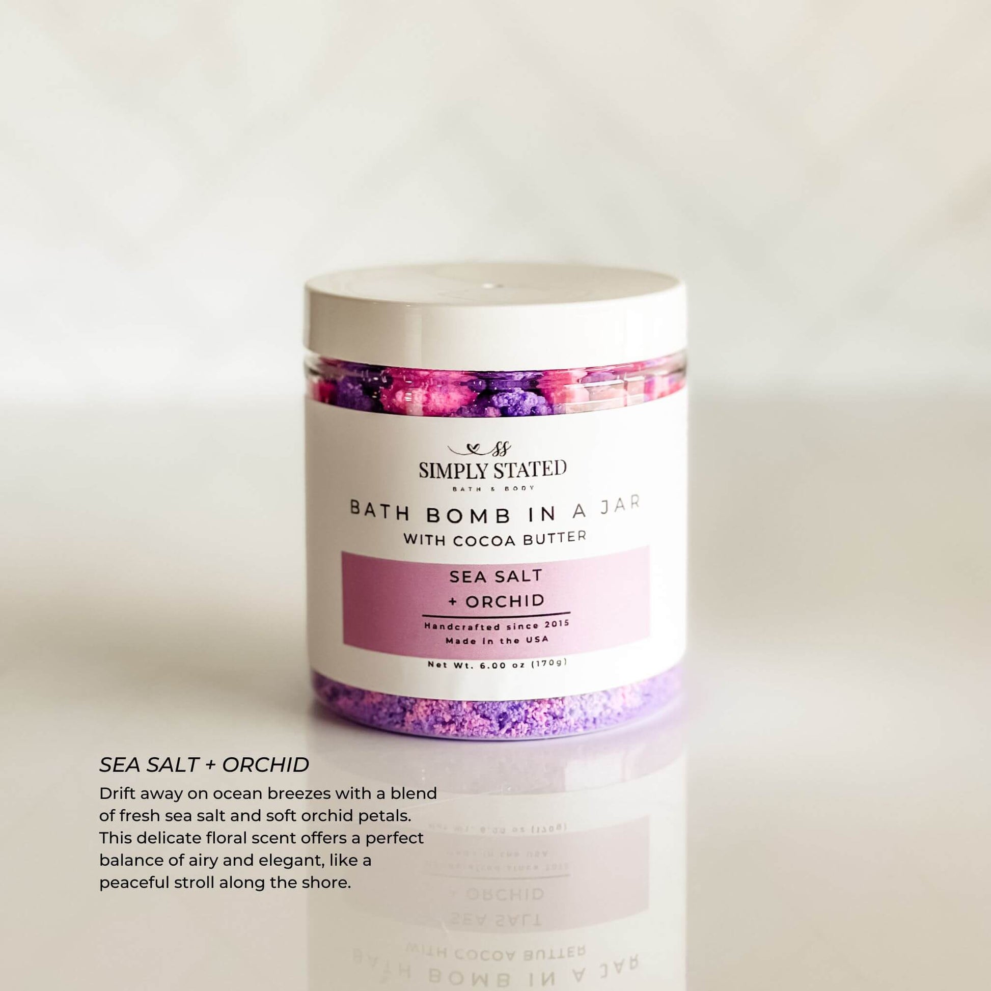 Simply Stated Bath & Body Signature Line Bath Bomb in a Jar - Sea Salt + Orchid. A refreshing mix of sea salt and delicate orchid petals, designed to transform bath time into a spa-like escape with skin-softening ingredients.