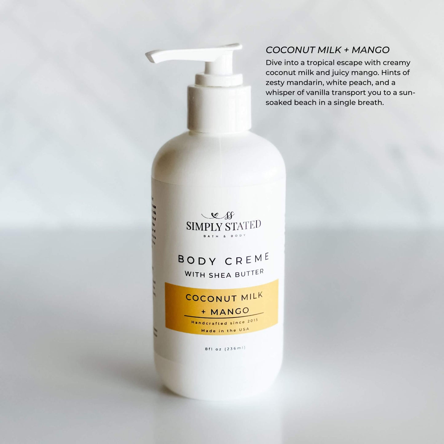 8oz pump bottle of Simply Stated Bath & Body Coconut Milk + Mango Body Creme with shea butter, featuring a tropical scent and moisturizing benefits.
