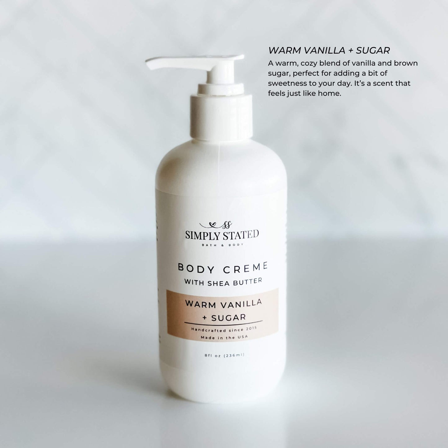 8oz pump bottle of Simply Stated Bath & Body Warm Vanilla + Sugar Body Creme with shea butter, delivering a cozy vanilla and brown sugar scent.
