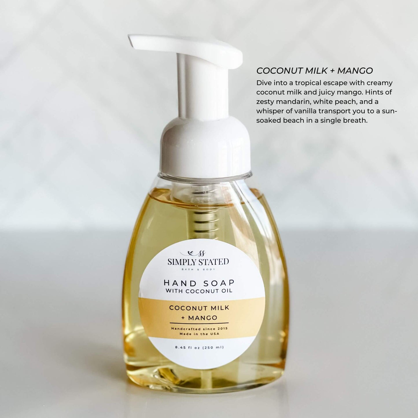 Simply Stated Bath & Body Signature Hand Soap with Coconut Milk + Mango fragrance in an 8oz foaming pump bottle, displayed with a tropical and refreshing scent profile. Perfect for hydrating and cleansing hands naturally.
