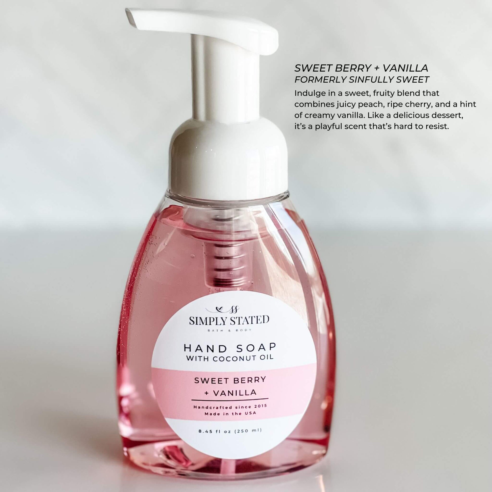 Signature Sweet Berry + Vanilla Hand Soap by Simply Stated Bath & Body, featuring a vibrant pink 8oz pump bottle. Indulge in the sweet and fruity scent for a joyful hand wash.