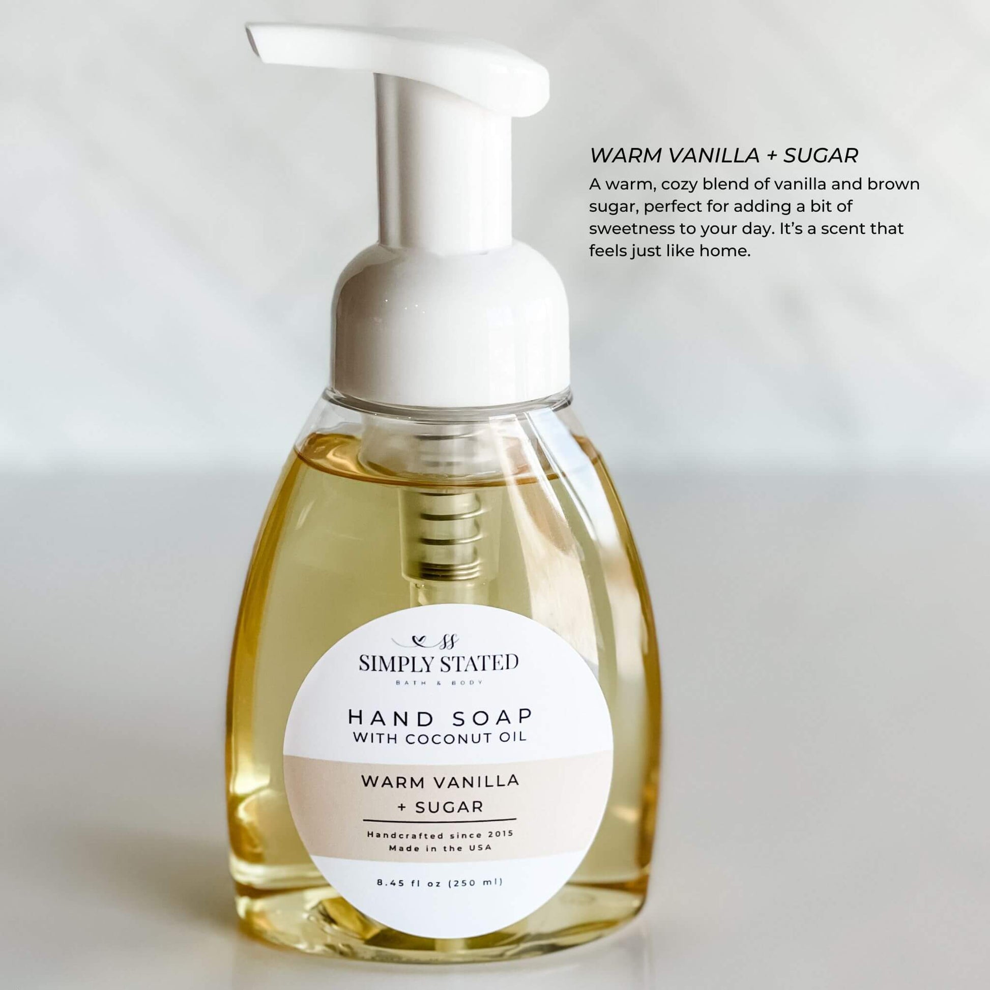 Warm Vanilla + Sugar Signature Hand Soap by Simply Stated Bath & Body in an 8oz pump bottle. A cozy, sweet scent of vanilla and brown sugar for an at-home spa-like experience.