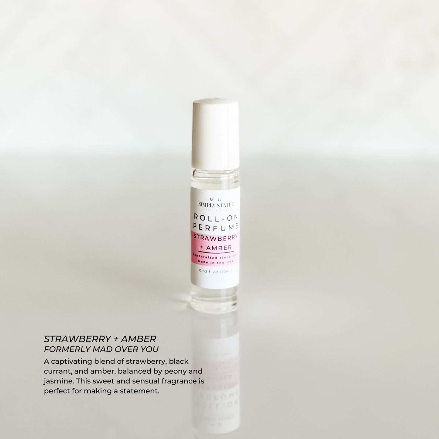 Simply Stated Signature Roll-On Perfume in Strawberry + Amber scent. A bold blend of juicy strawberry, black currant, and amber, balanced with jasmine and peony.
