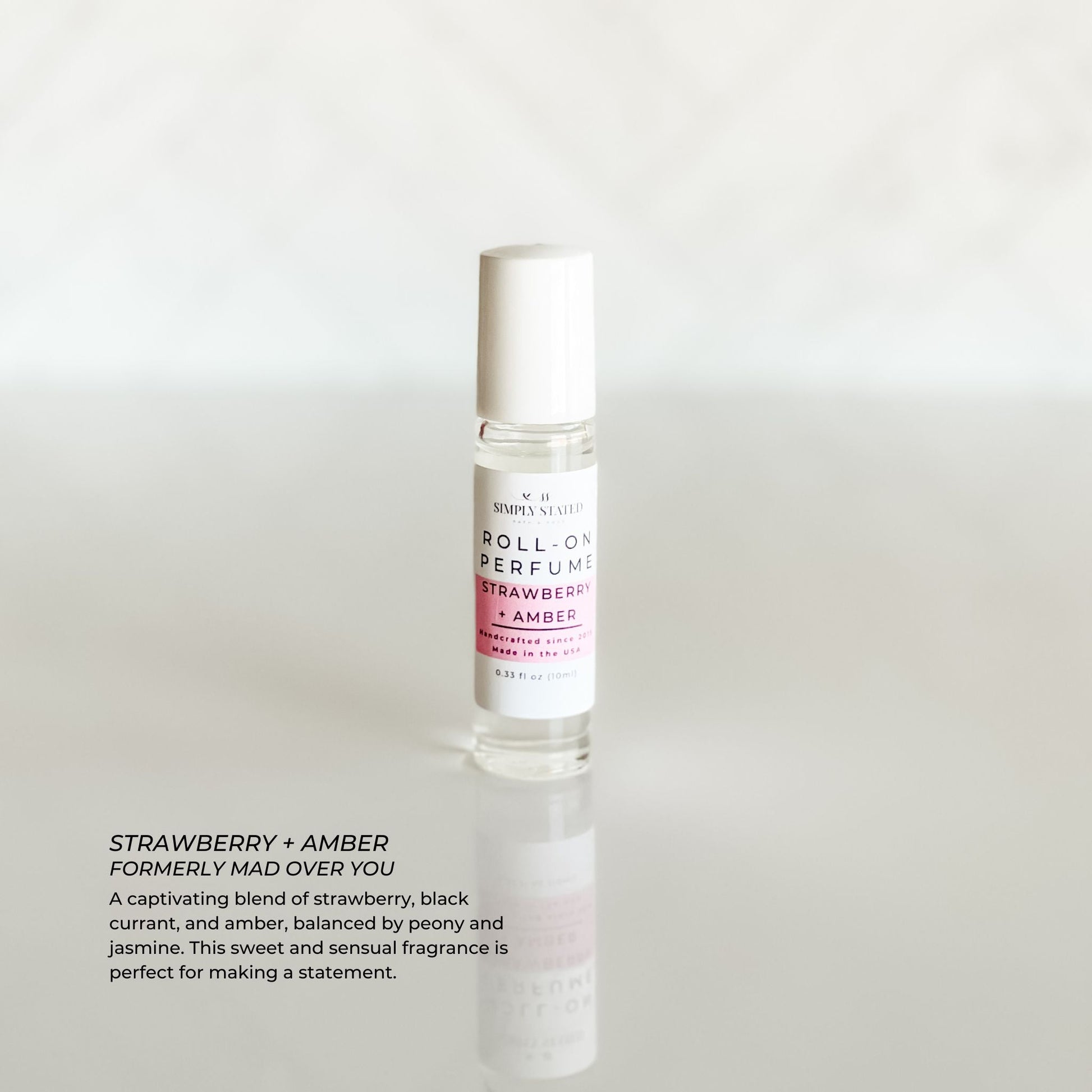 Simply Stated Signature Roll-On Perfume in Strawberry + Amber scent. A bold blend of juicy strawberry, black currant, and amber, balanced with jasmine and peony.
