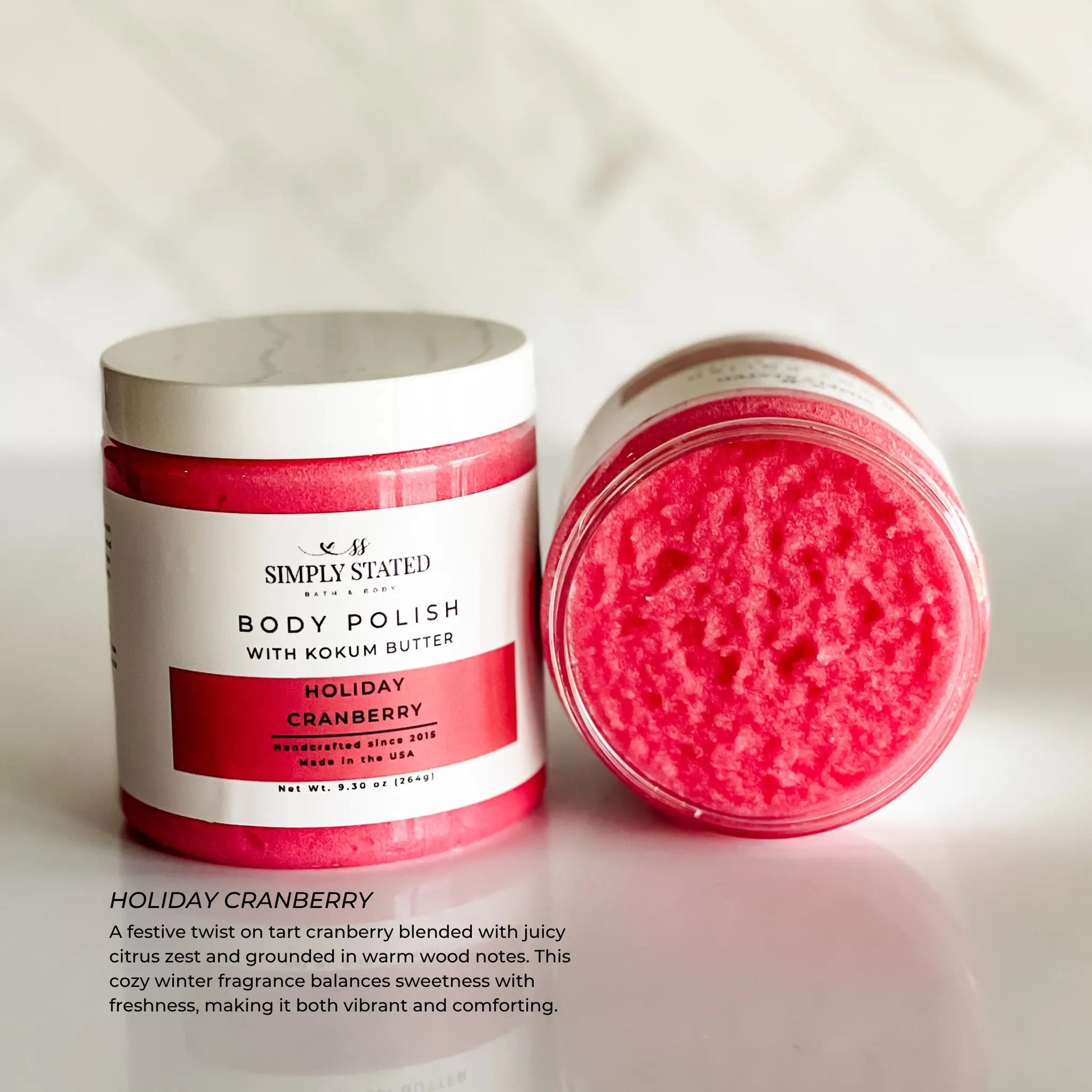 Body polish with holiday cranberry scent on a white background